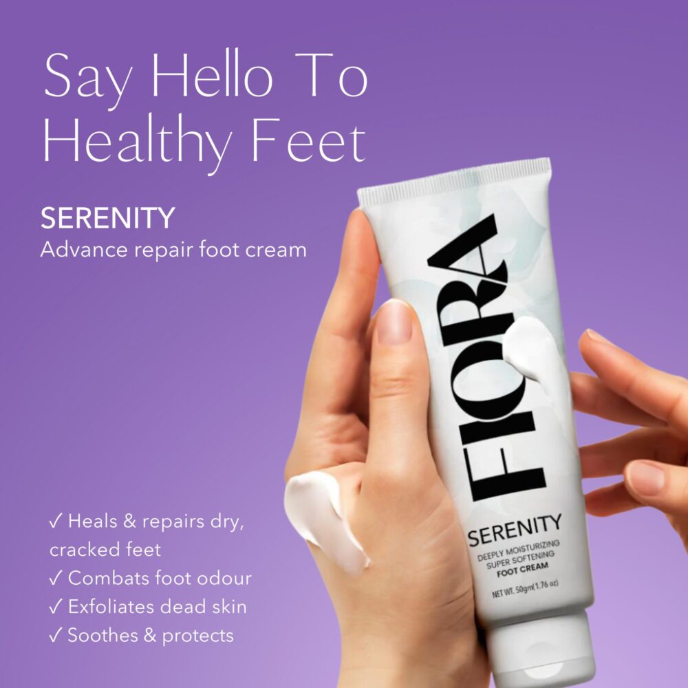 hand holding white cream tube in purple background